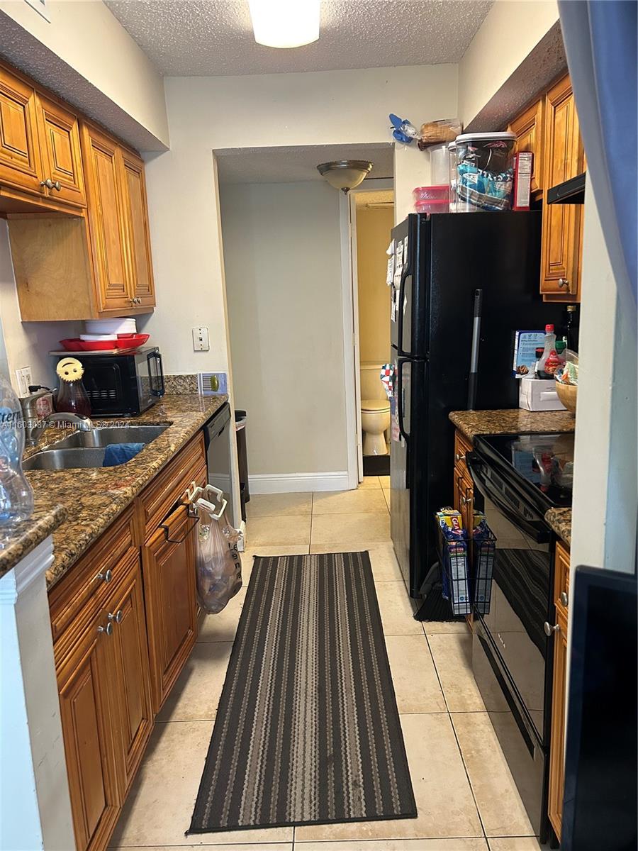 a kitchen with a sink appliances and cabinets