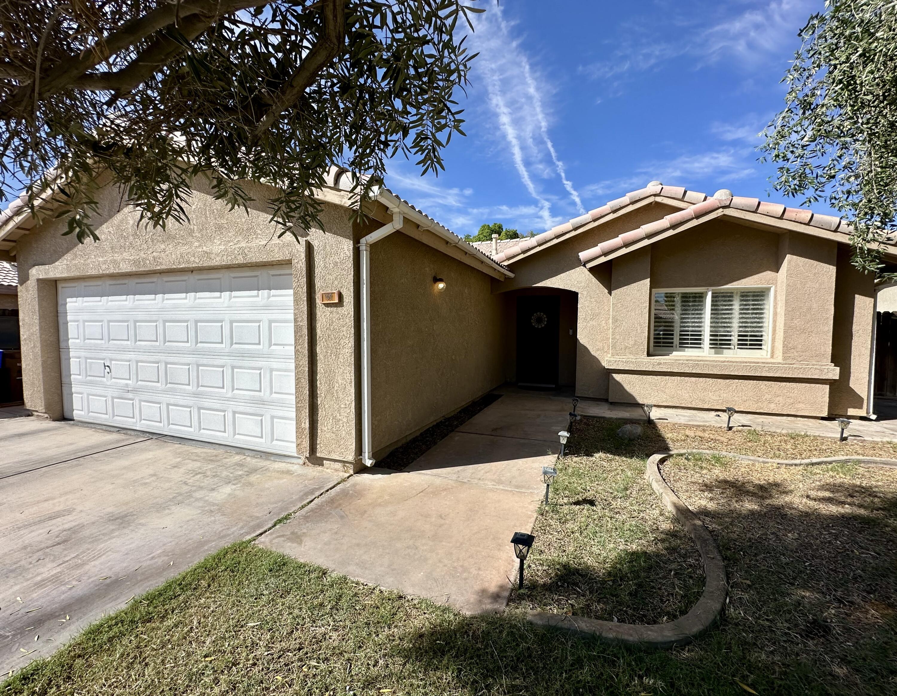 a front view of a house with a yard