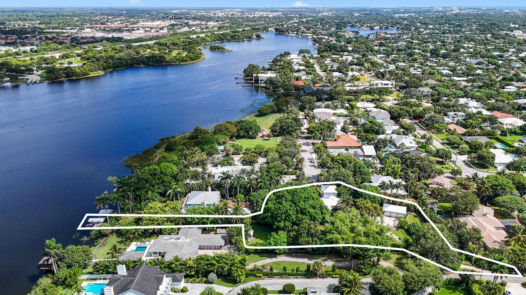 an aerial view of residential houses with outdoor space and trees