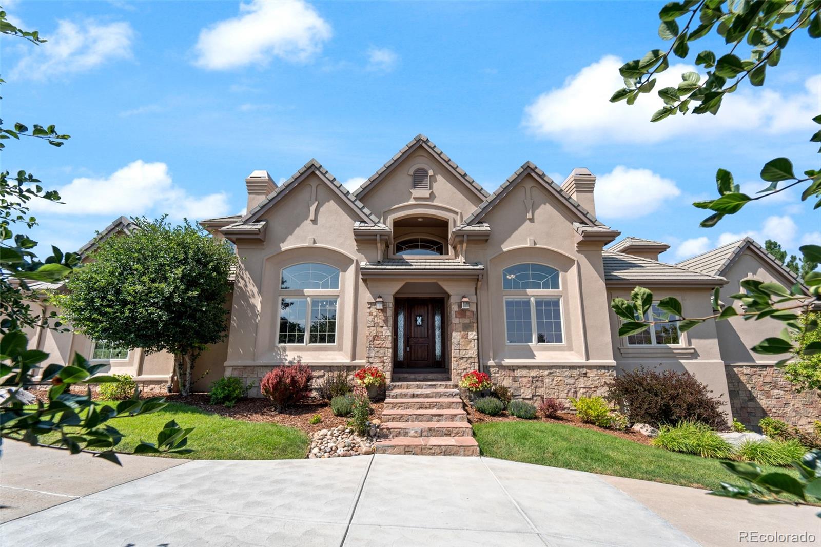 a front view of a house with garden