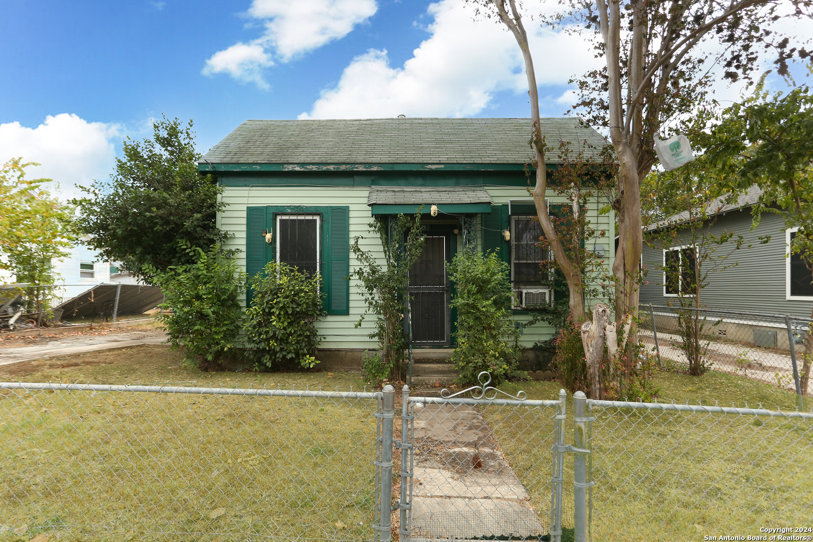 a view of a brick house with potted plants