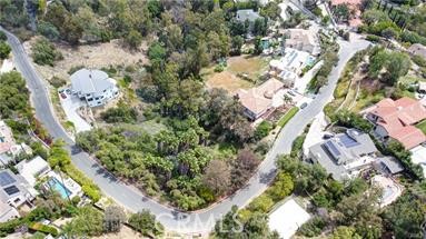 an aerial view of a house with a yard and garden