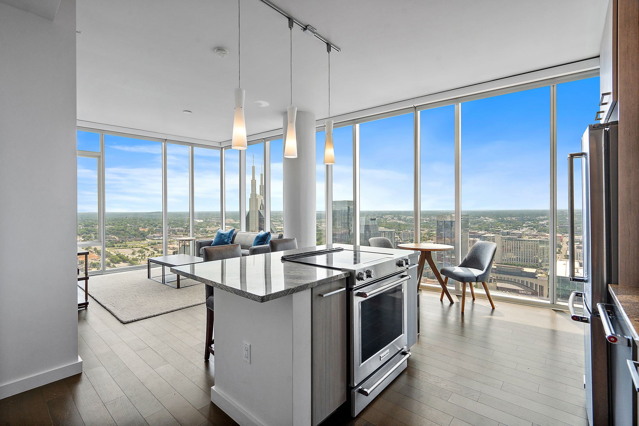 a very nice looking living room with a large window and kitchen view