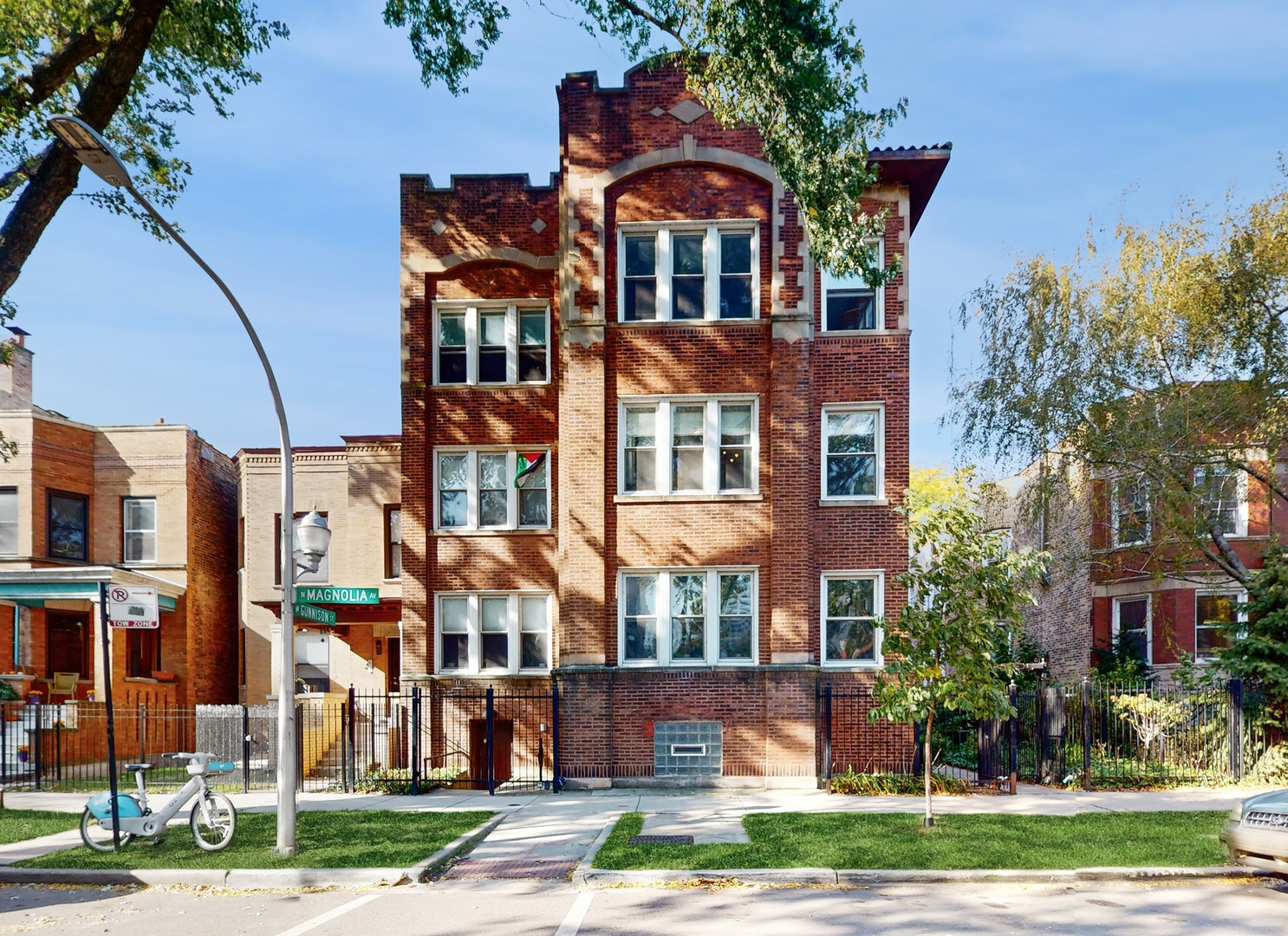 a front view of a residential apartment building with a yard