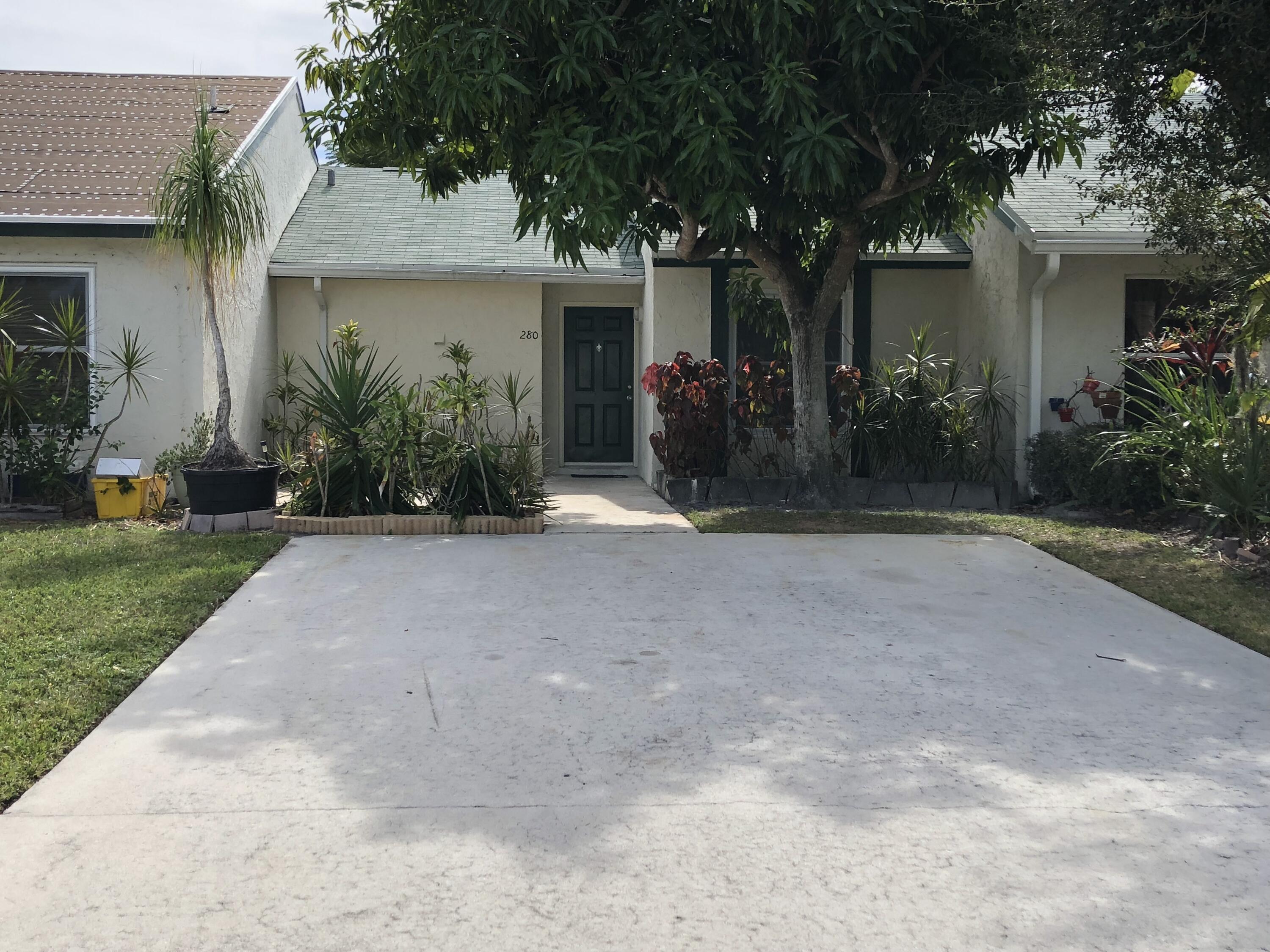 a view of a house with outdoor space and a yard