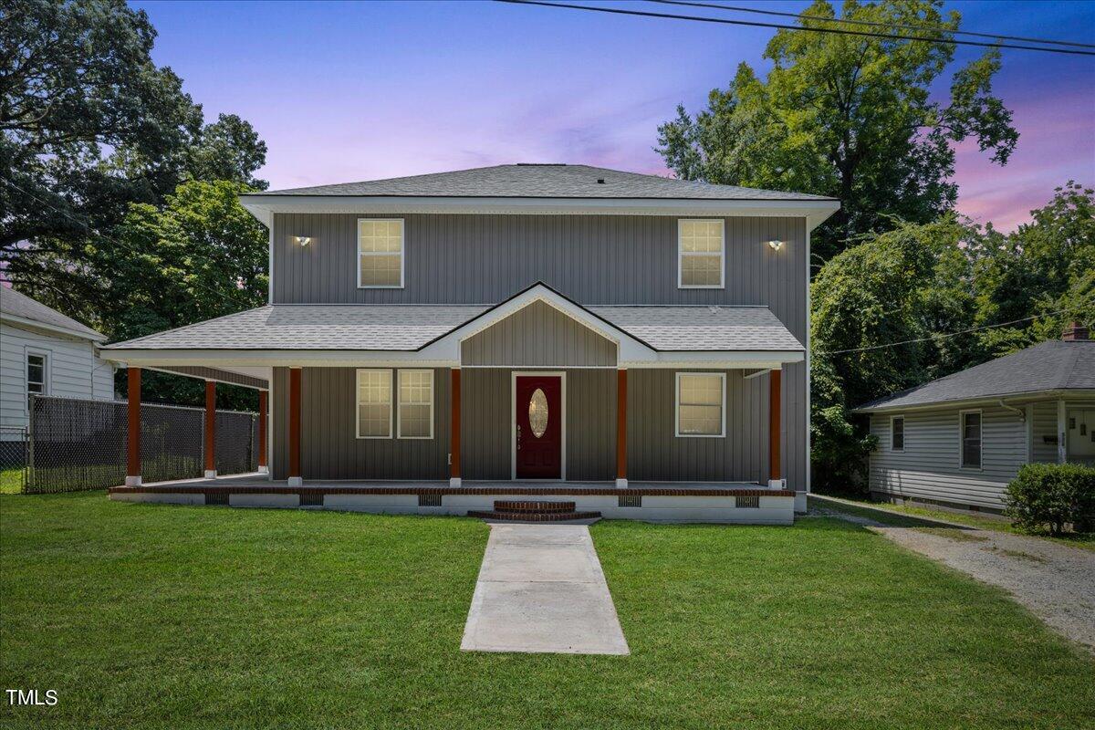 a front view of house with yard and green space