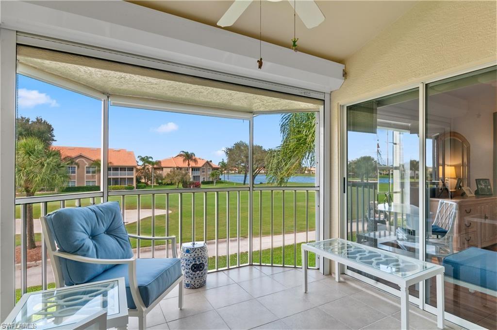 a balcony with furniture and a floor to ceiling window