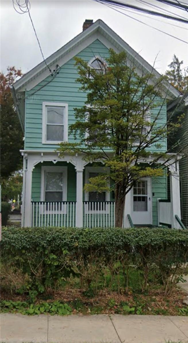 a front view of a house with a garden