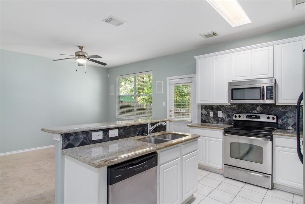 a kitchen that has a sink and a stove