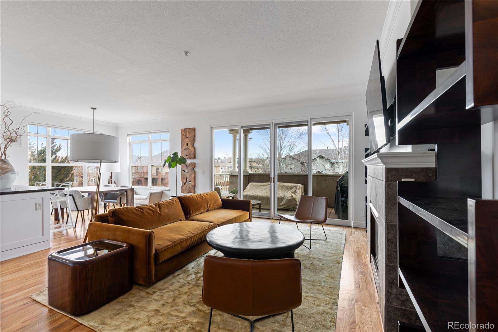 a living room with fireplace furniture and a floor to ceiling window