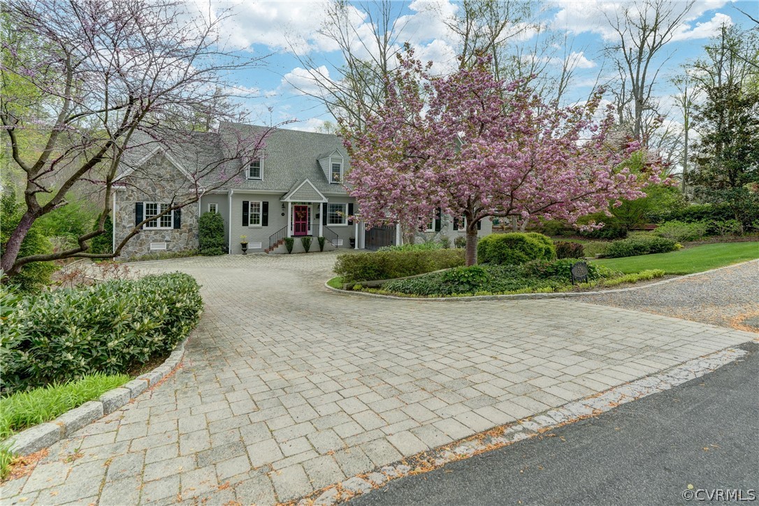 a front view of a house with a yard and trees