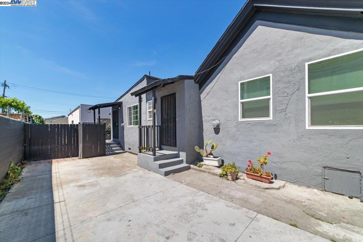 a backyard of a house with table and chairs