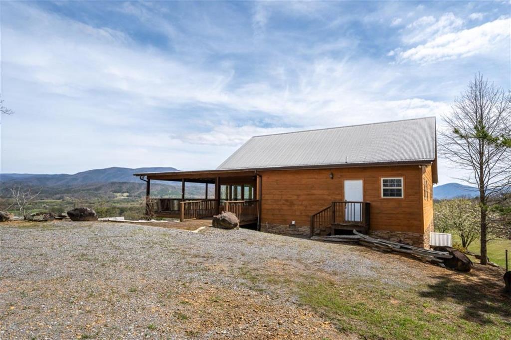 a backyard of a house with yard and mountain view in back