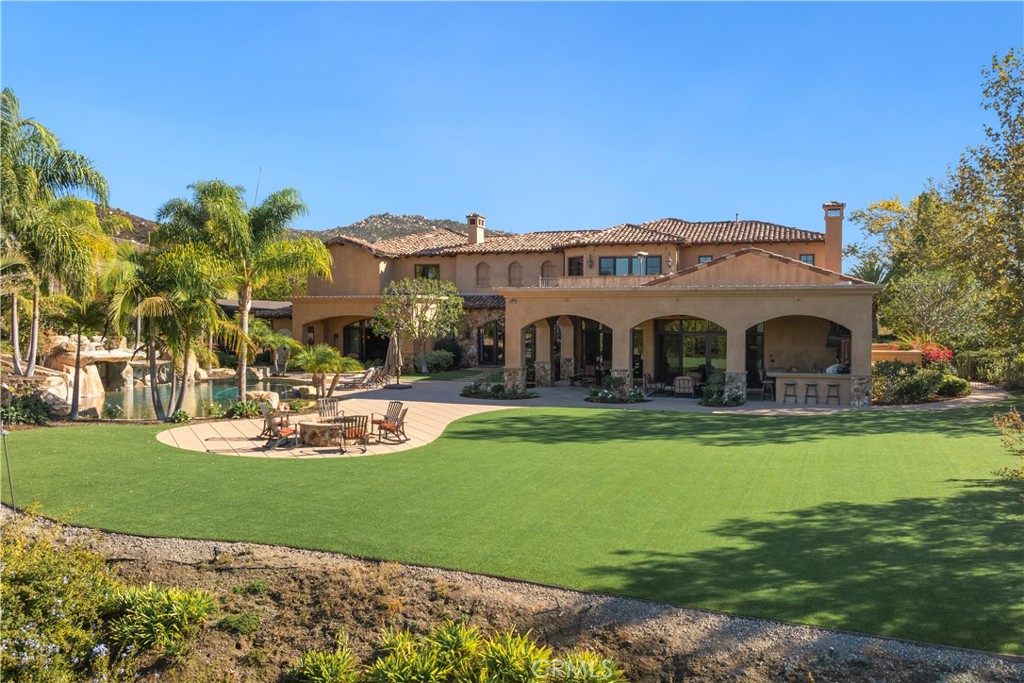 a front view of a house with swimming pool having outdoor seating