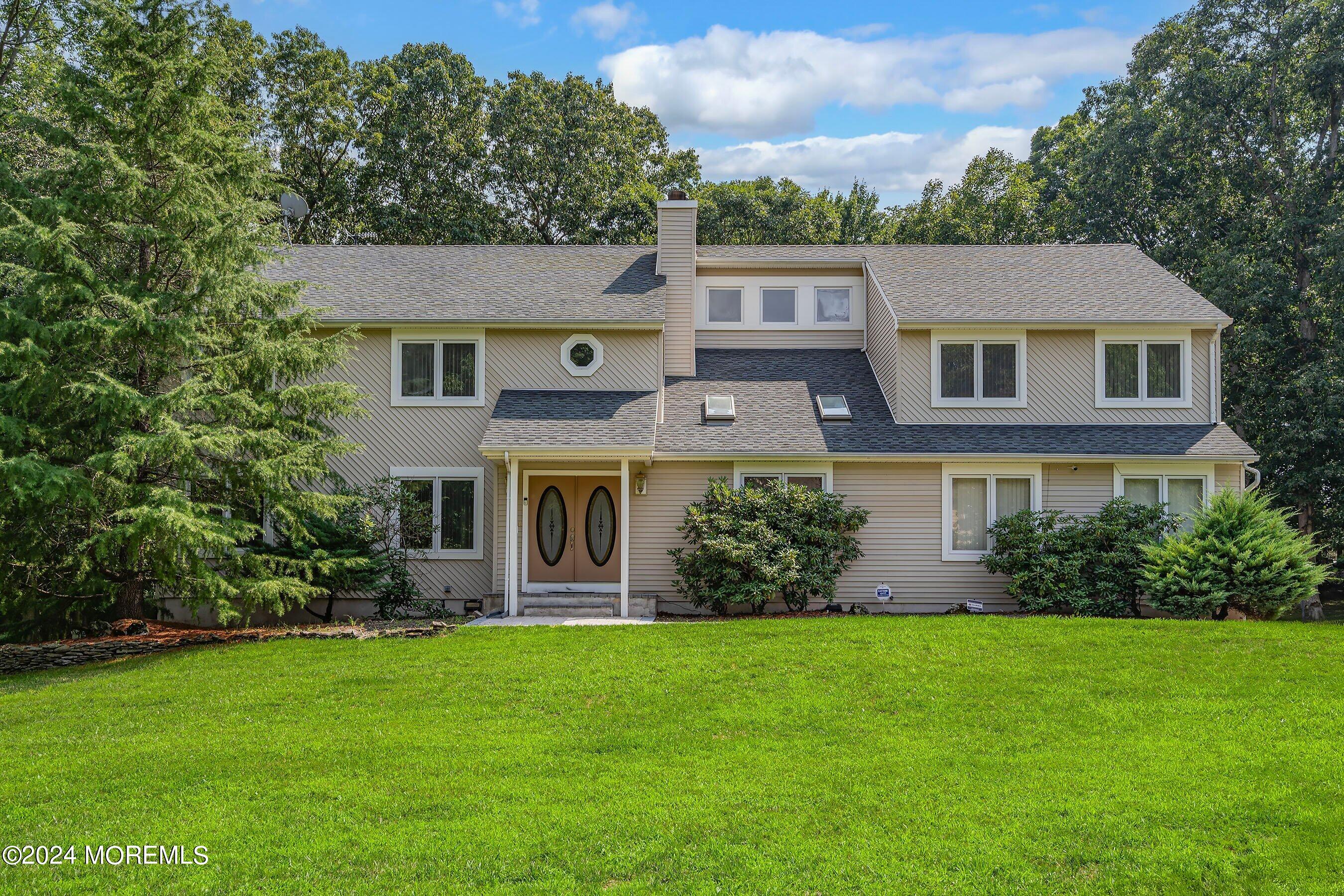 a front view of house with yard and green space