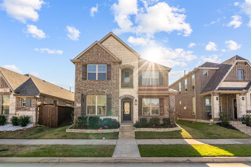 a front view of a house with yard and green space