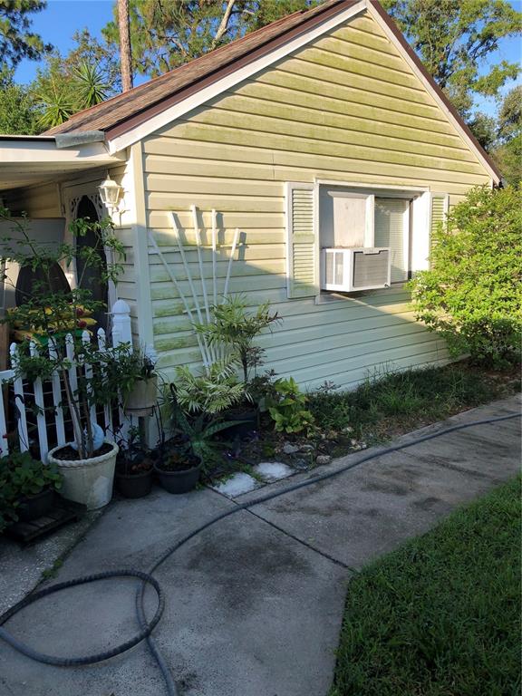 a view of a house with backyard and sitting area