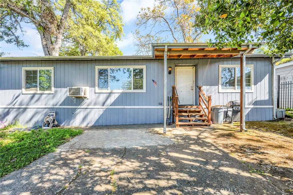 a view of a house with a patio and a yard