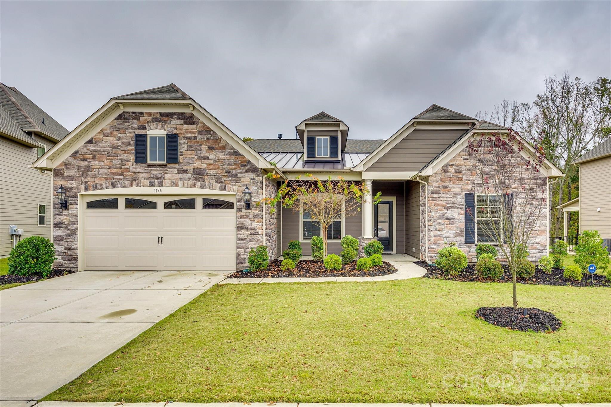 a front view of a house with a yard