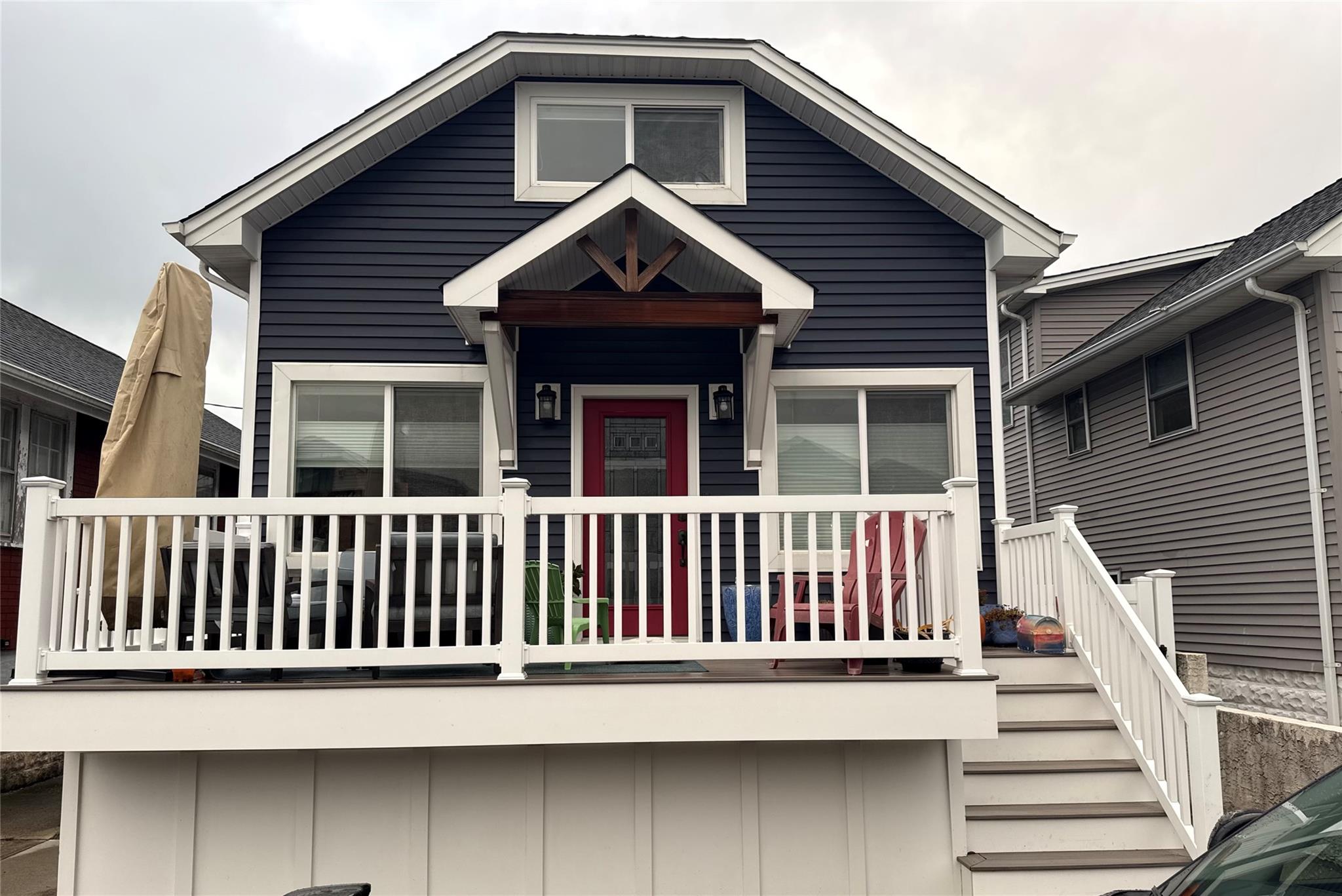 a view of wooden house with a small deck