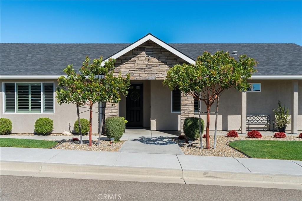 a front view of a house with garden