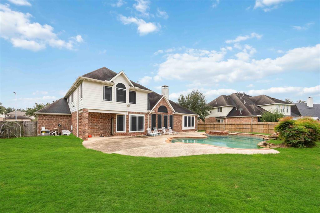 a front view of a house with garden and lake view