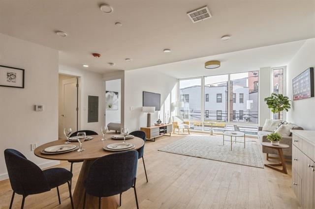 a large kitchen with a table and chairs