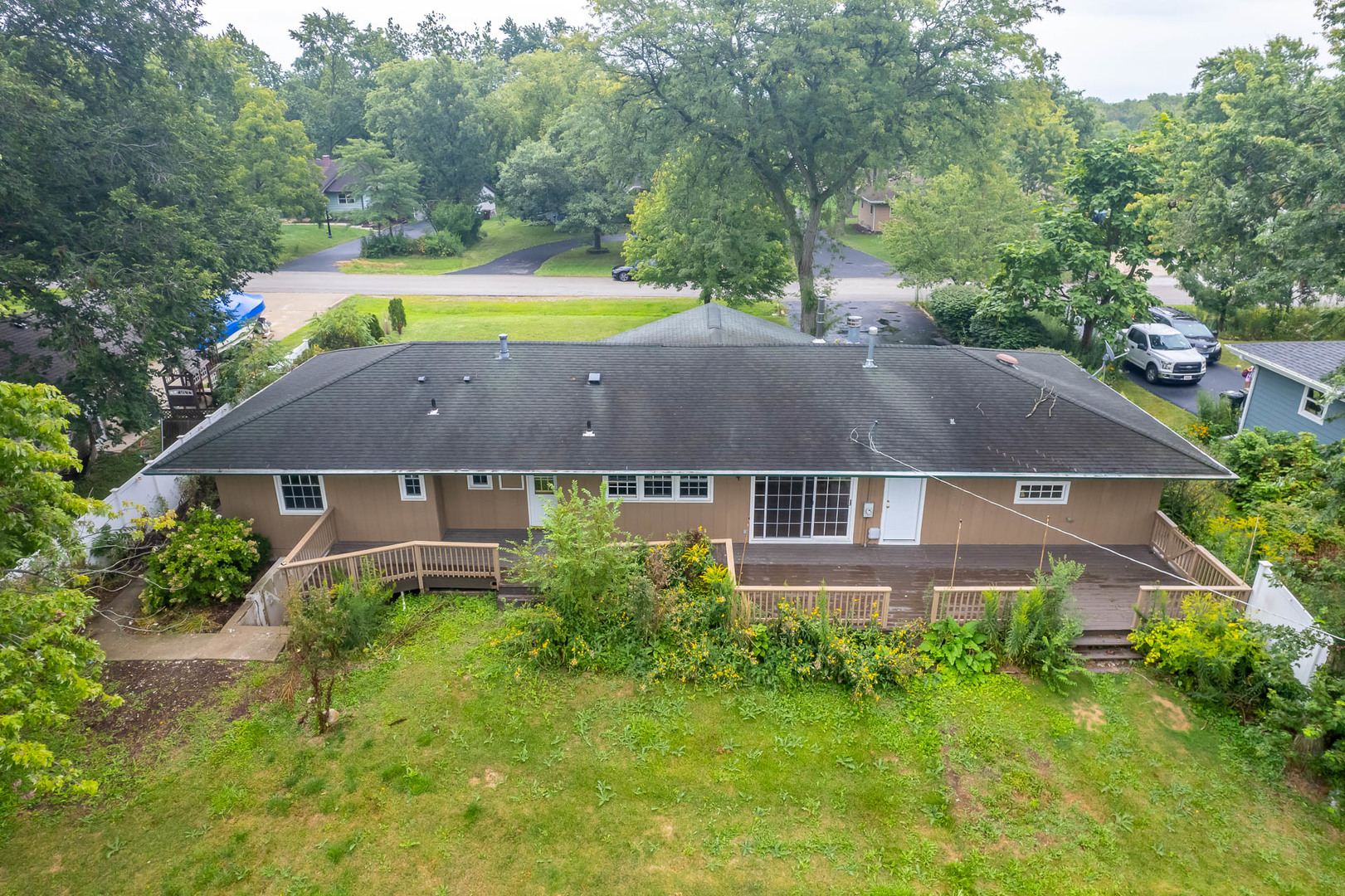 an aerial view of a house with a big yard