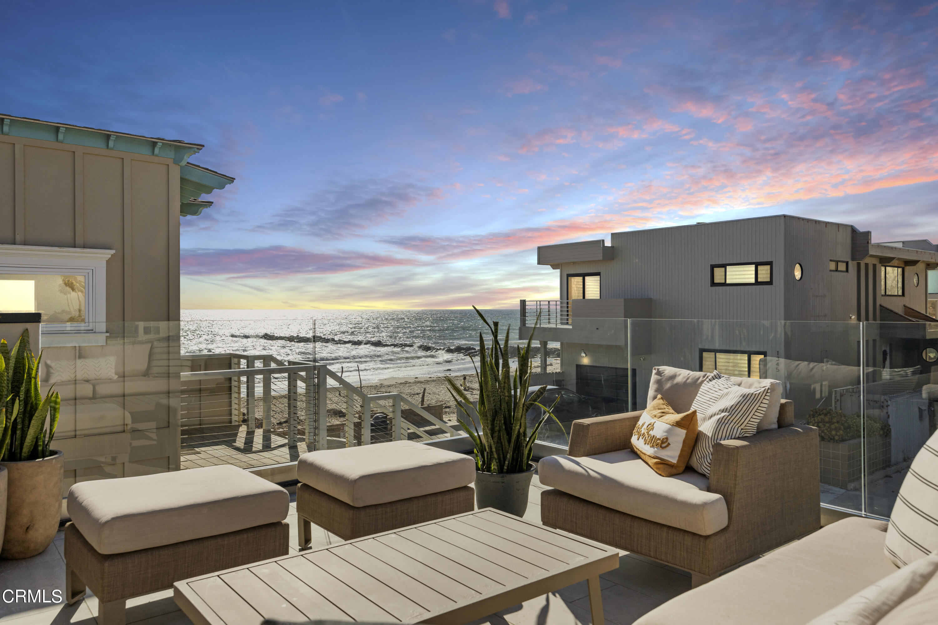 a view of roof deck with couches and potted plants