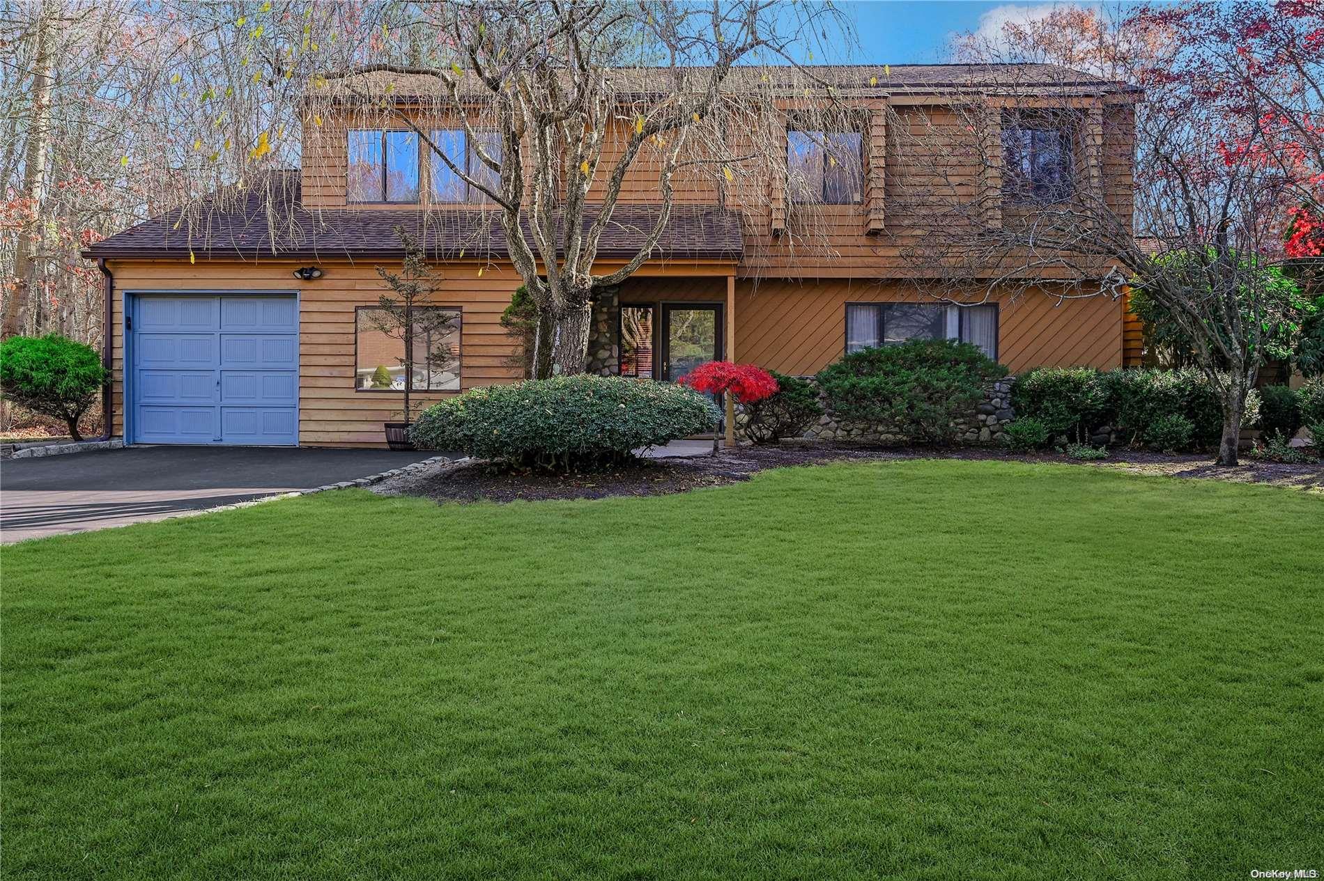 a front view of a house with a garden and yard