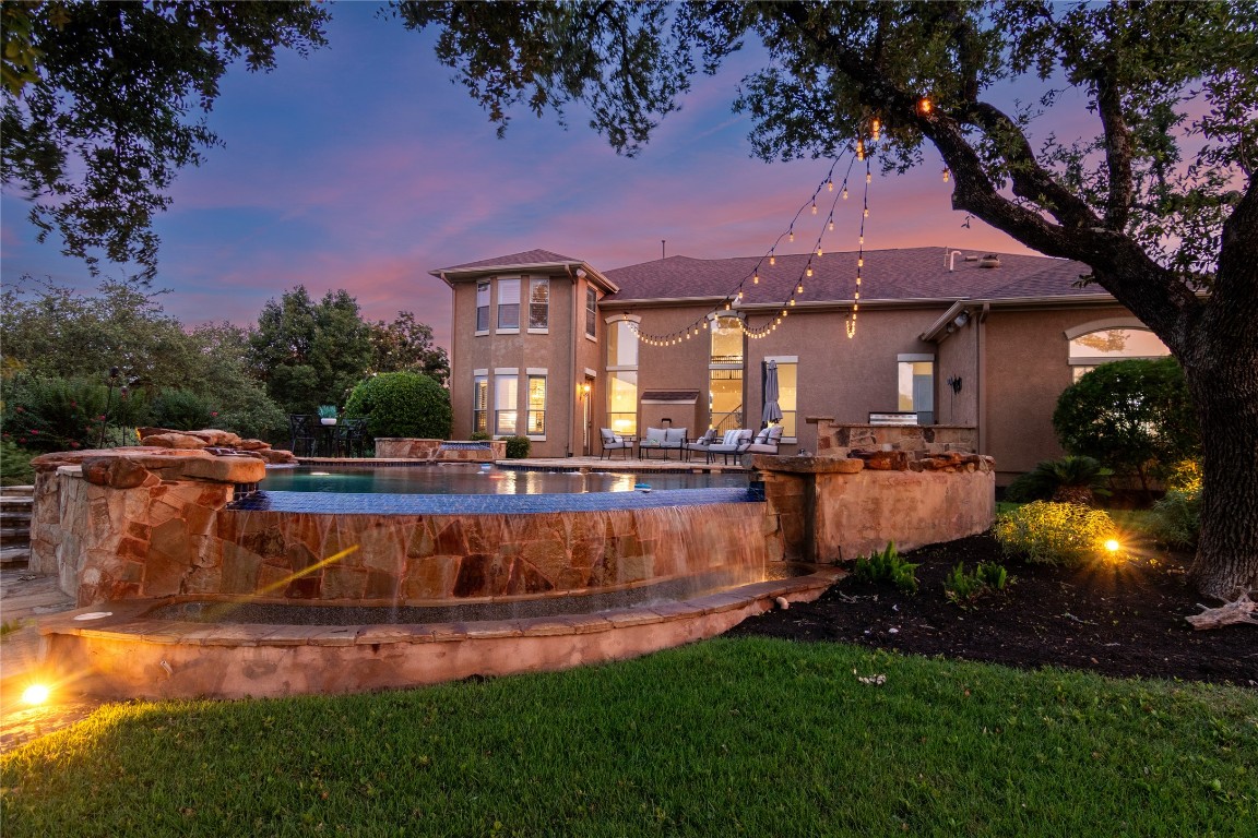 a view of a swimming pool with an outdoor seating and a yard