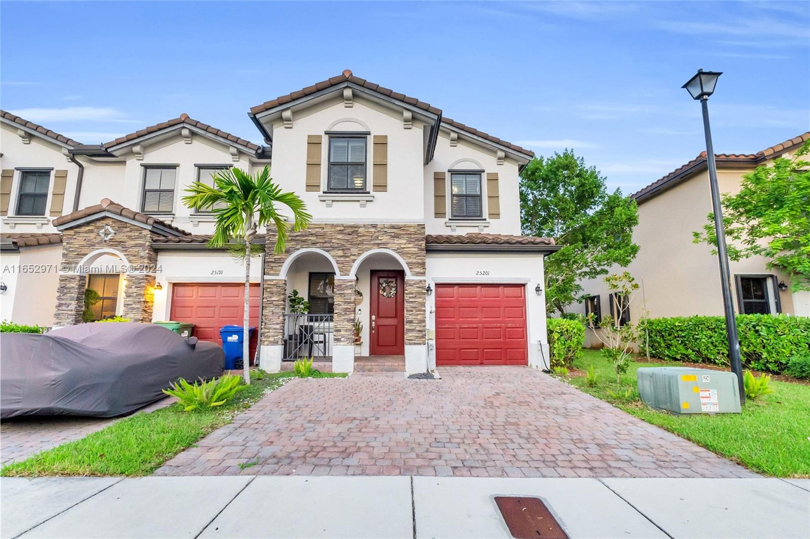 a front view of a house with a yard and garage