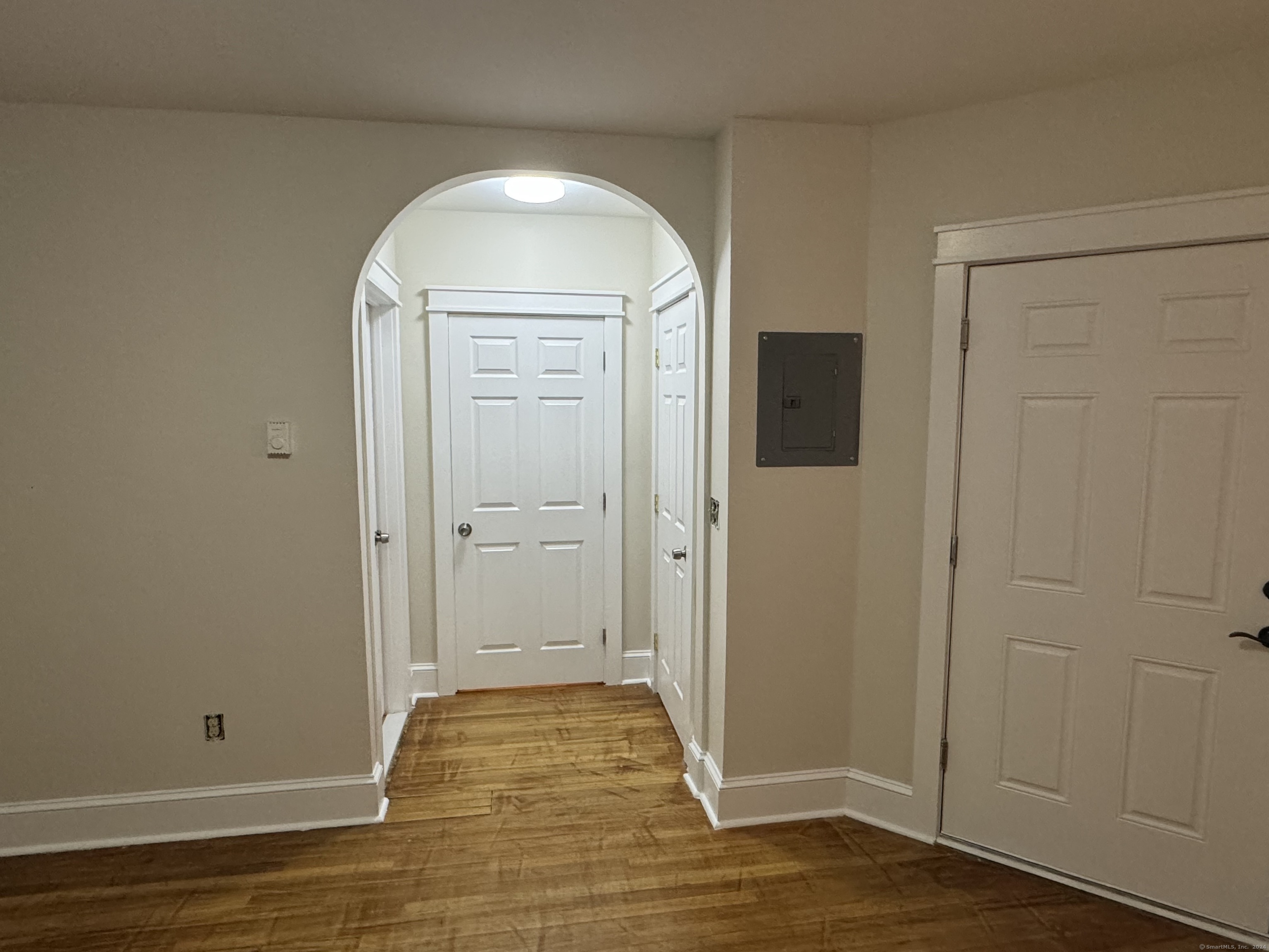 a view of room with window and hardwood floor