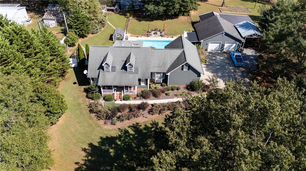 an aerial view of a house with yard swimming pool and outdoor seating