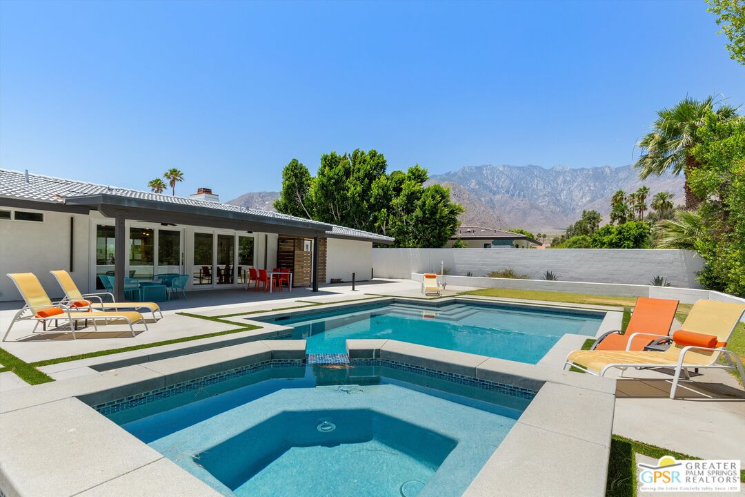 a view of house with swimming pool outdoor seating