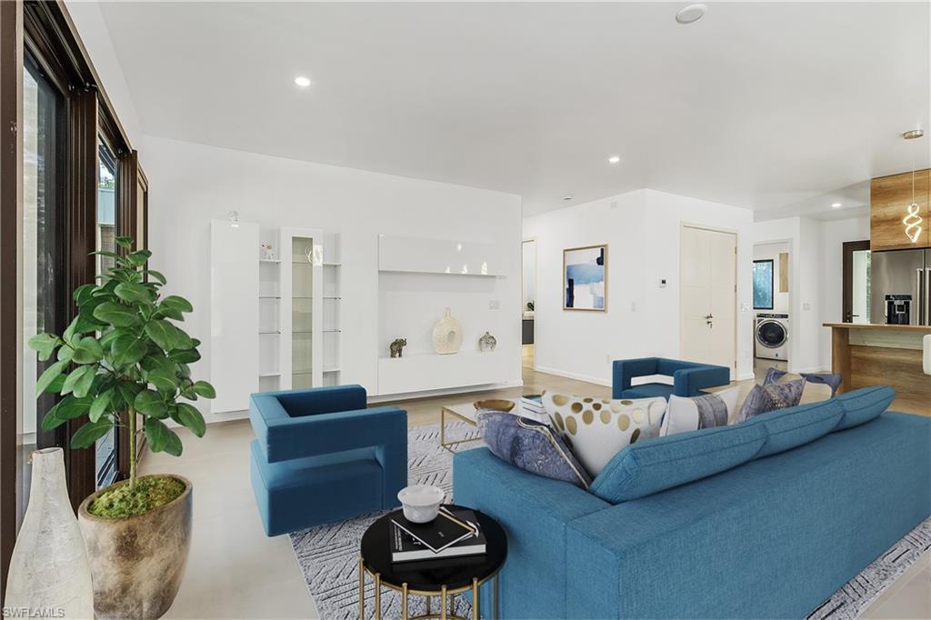 a living room with furniture and a potted plant