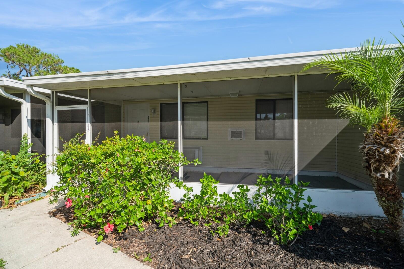 front view of a house with potted plants