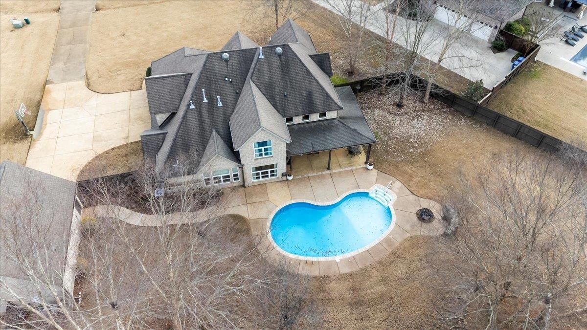 an aerial view of a house with swimming pool