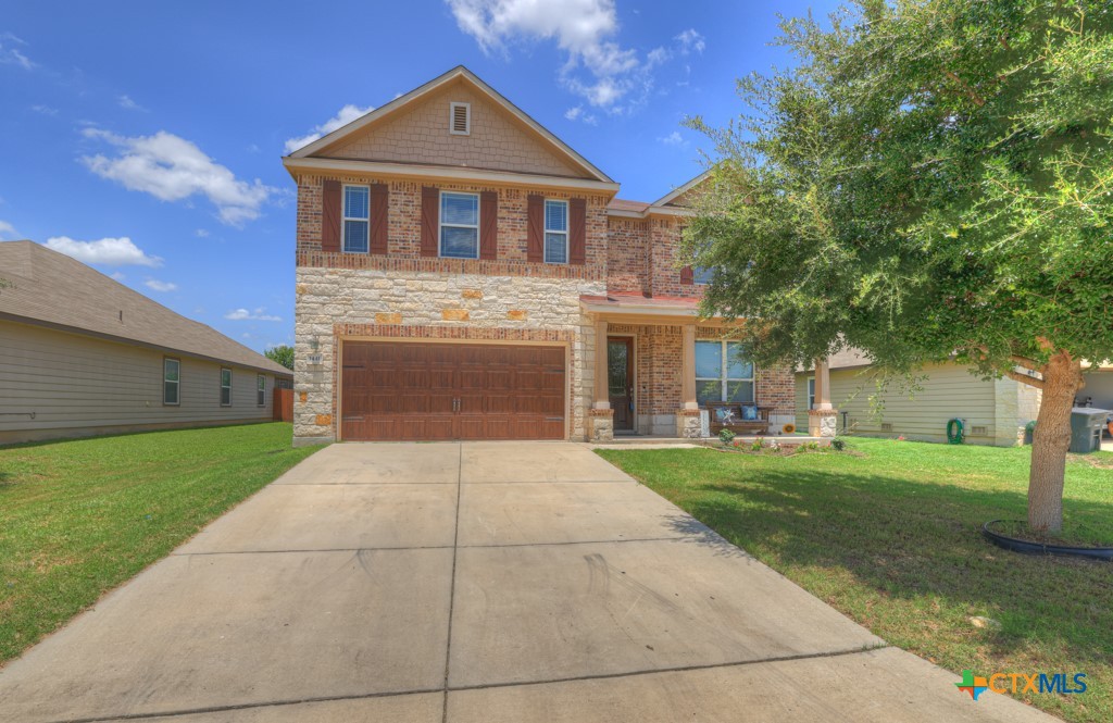 a front view of a house with a yard