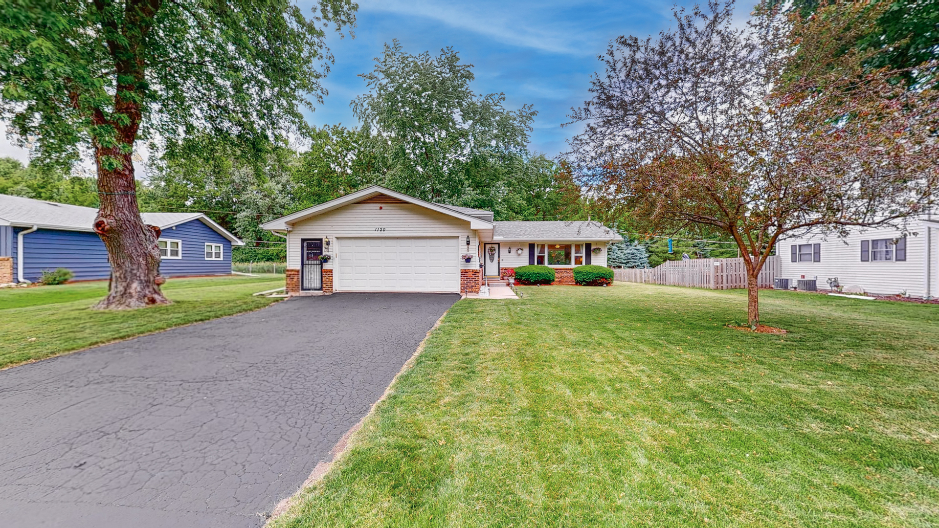 a front view of house with yard and green space