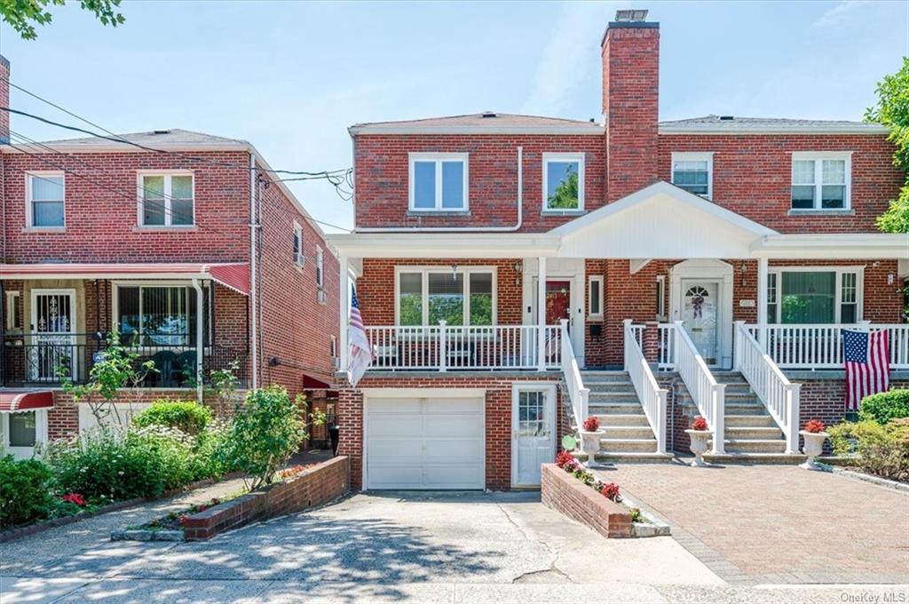 Multi unit property featuring a garage and covered porch