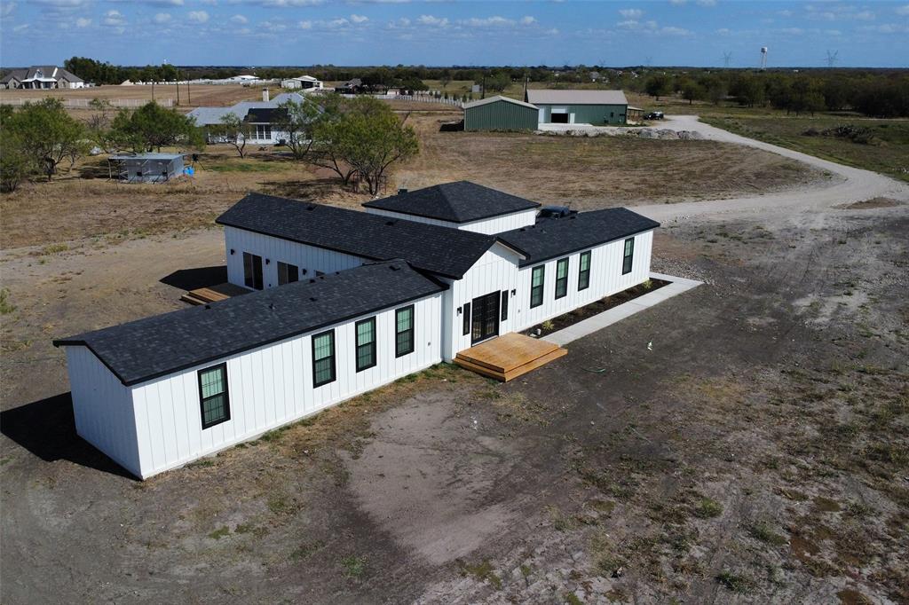 an aerial view of a house with a yard