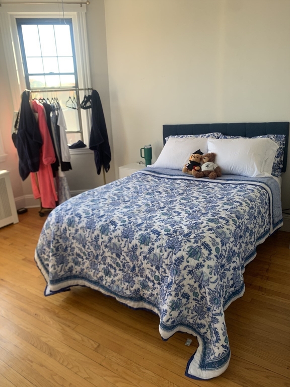 a bed sitting in a bedroom next to a window