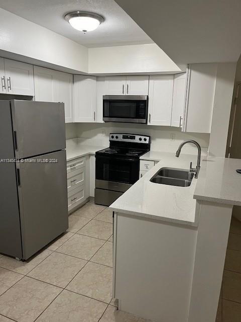 a kitchen with stainless steel appliances a refrigerator sink and microwave