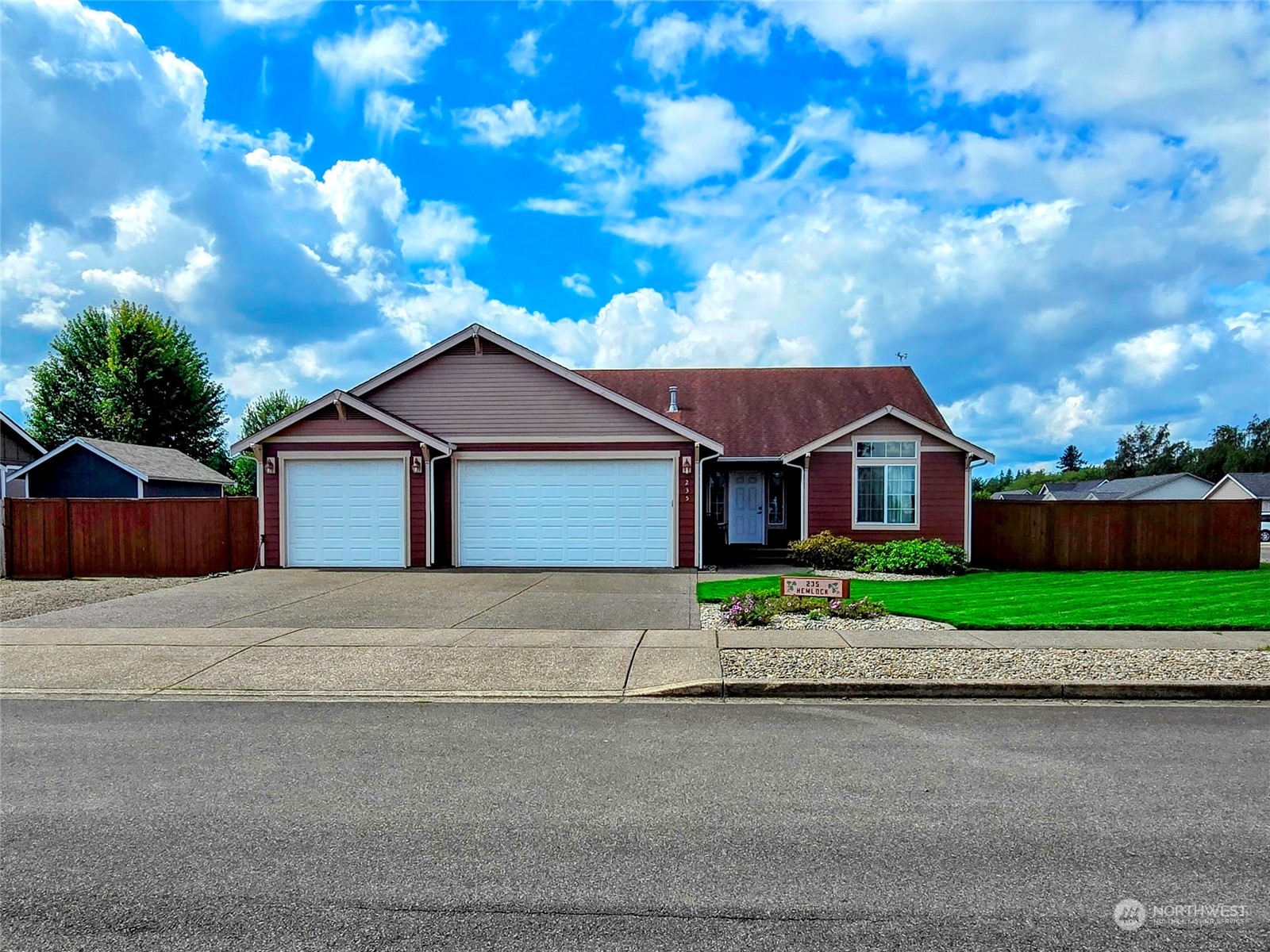 a front view of house with yard and green space