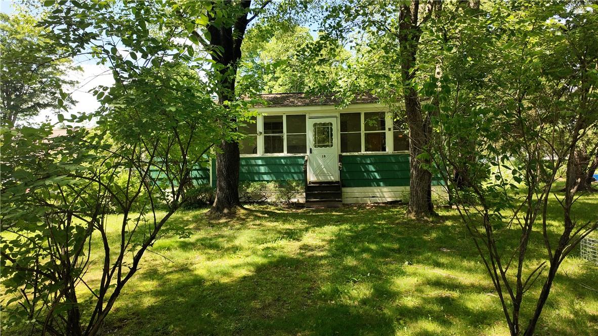 a view of house with backyard and a garden