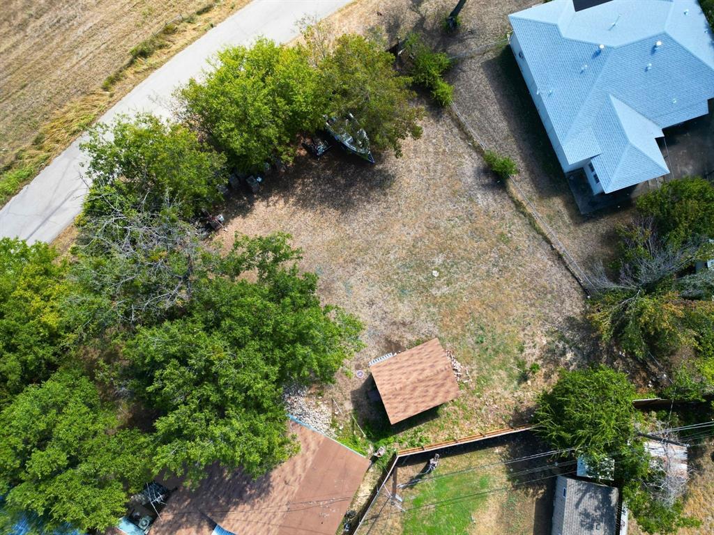 an aerial view of a house with a yard and lake view