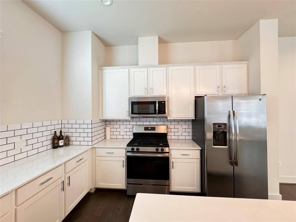 a kitchen with a refrigerator stove and sink