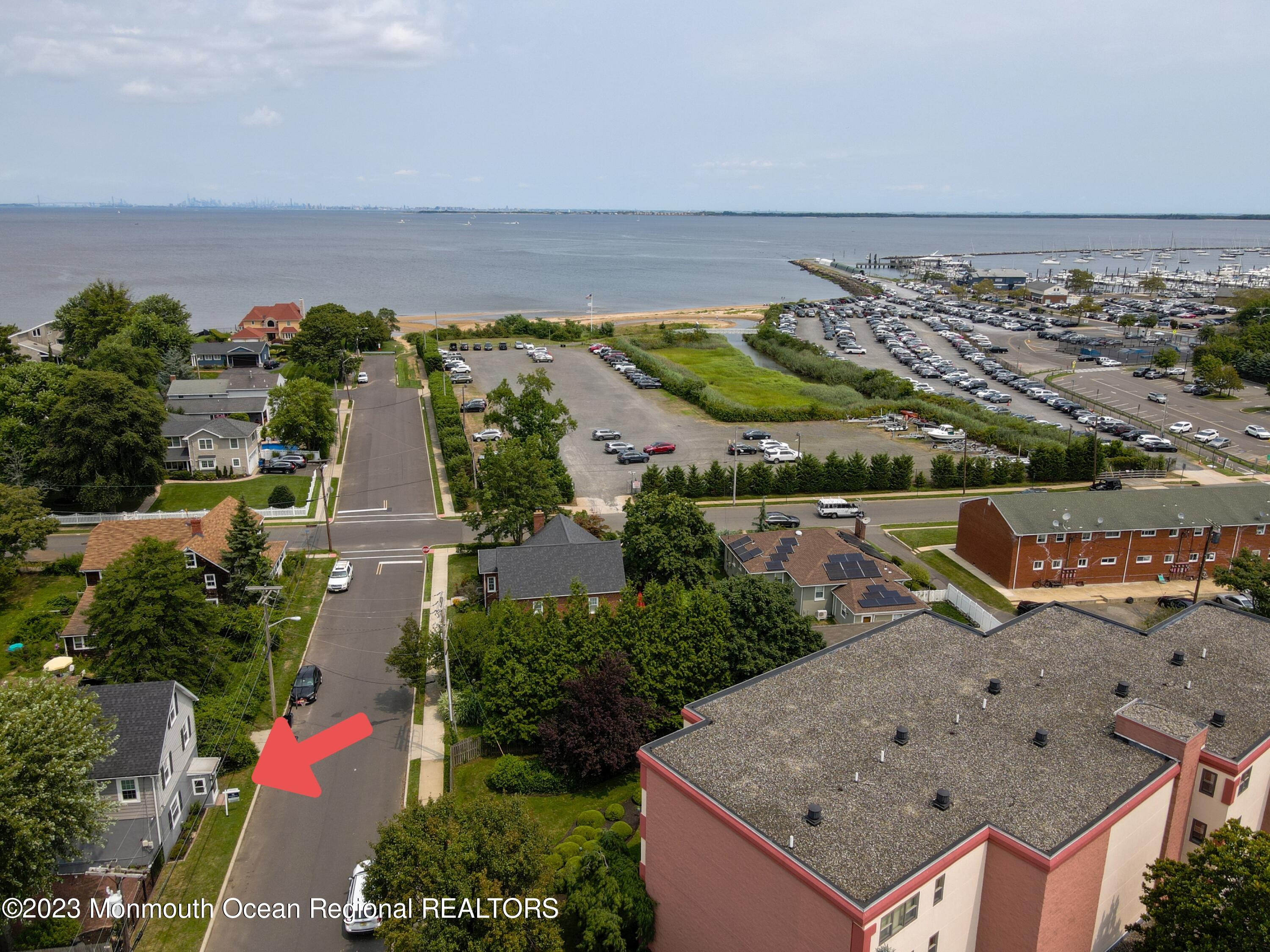 an aerial view of a house with a yard and lake view