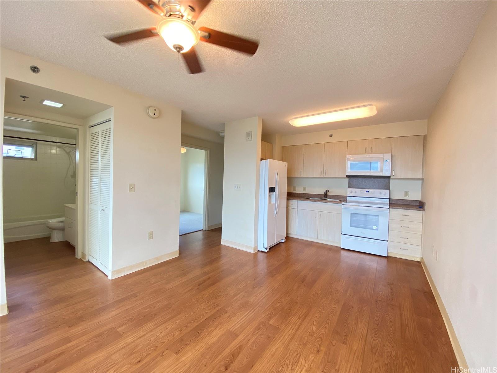 a view of a kitchen with wooden floor and a kitchen